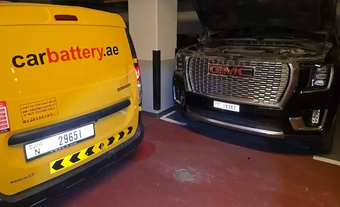 Mechanic inspecting a healthy GMC car battery