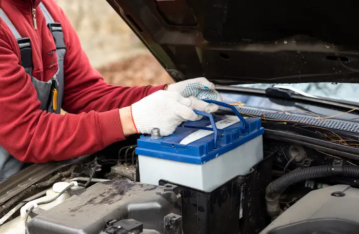 Mechanic checking a healthy Jeep car battery