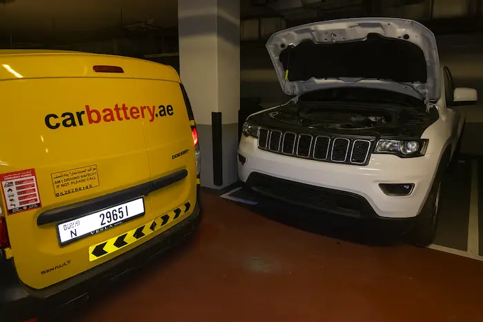 Technician performing Jeep battery replacement and diagnostic service